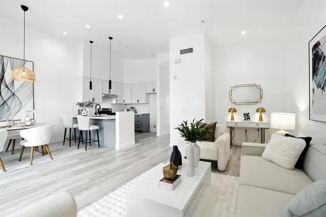 a living room with furniture a rug and white walls