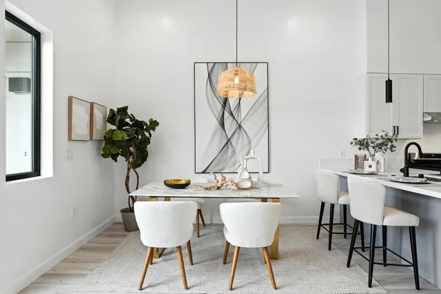 a dining room with furniture and wooden floor