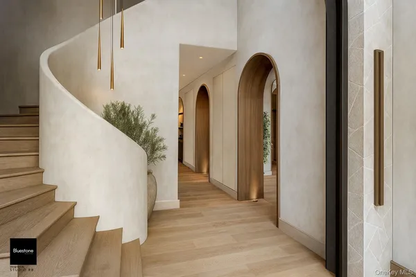 a view of entryway and hall with wooden floor