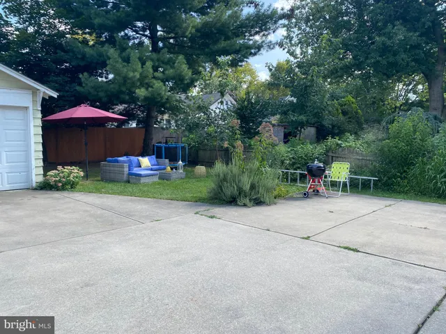 a couple of table and chairs under an umbrella
