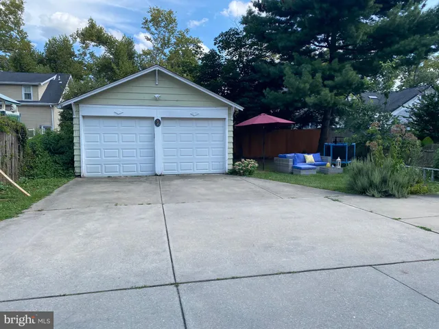a view of a house with a yard and garage