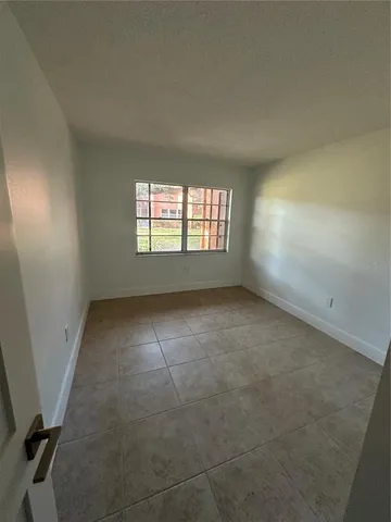 an empty room with a empty space and windows