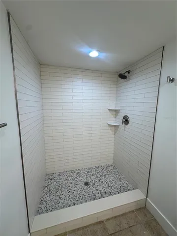 a bathroom with a granite countertop sink a toilet and a mirror