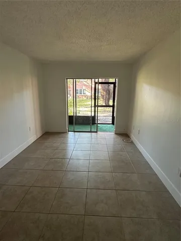 a view of porch with a floor to ceiling window next to a yard