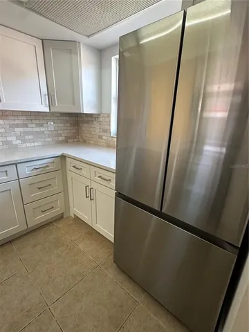 a white refrigerator freezer sitting inside of a kitchen