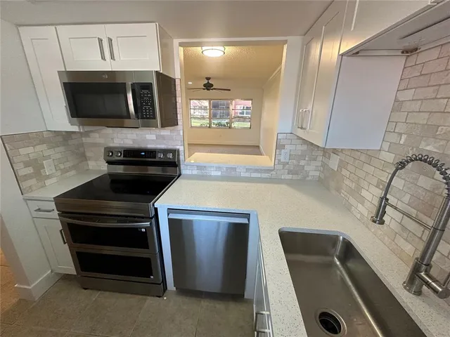 a kitchen with a stove and a microwave