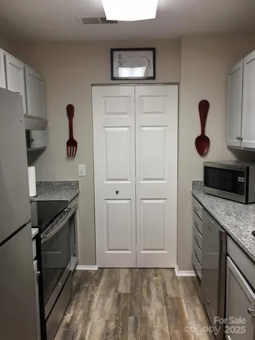 a kitchen with a sink and a stove top oven