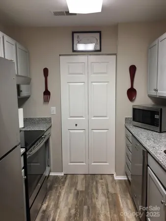 a kitchen with a sink and a stove top oven
