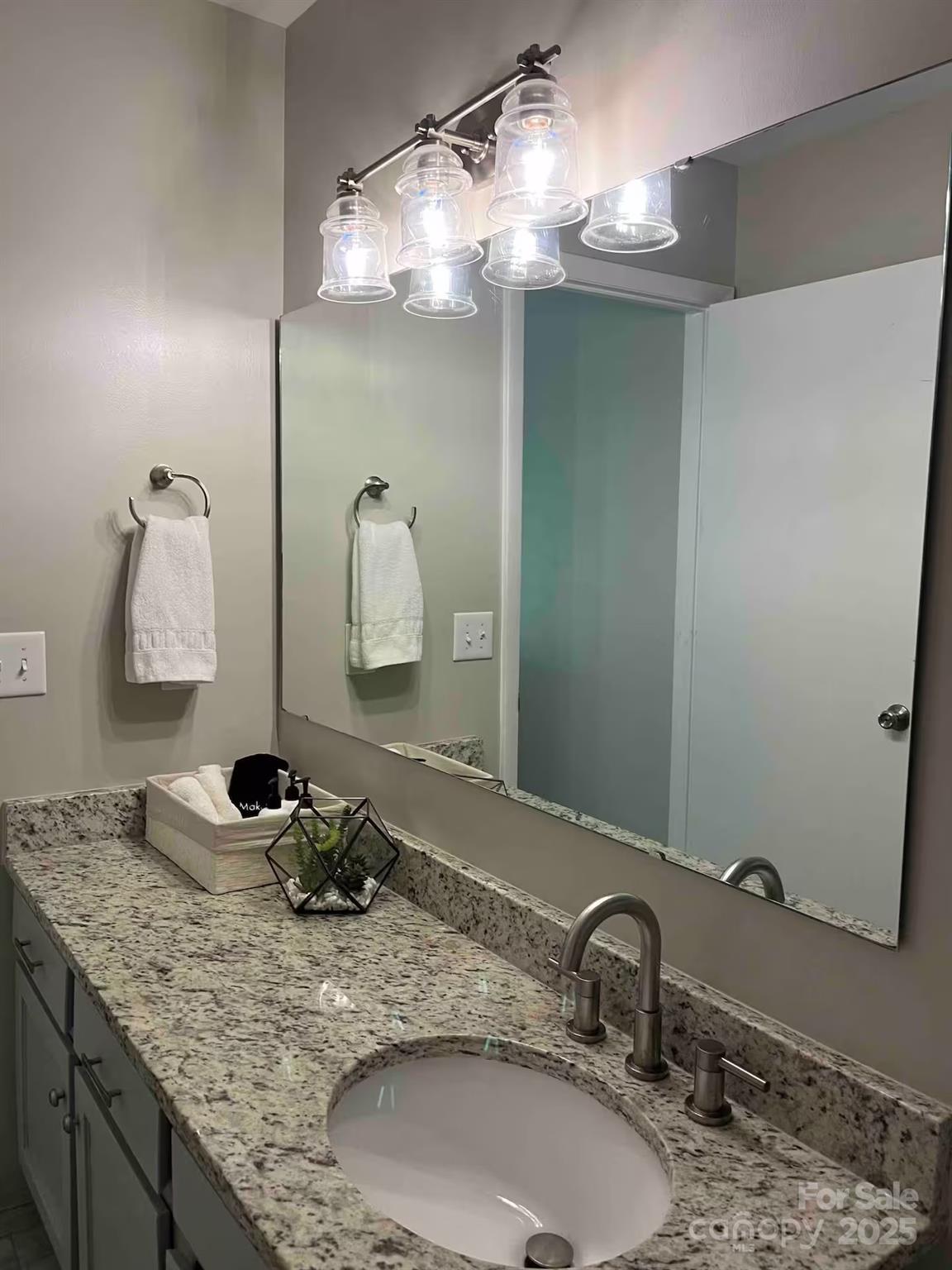 229 Windsor Point Road, Unit 6B Columbia, SC 29223 - Photo 9 of 15 a bathroom with a granite countertop sink and a mirror