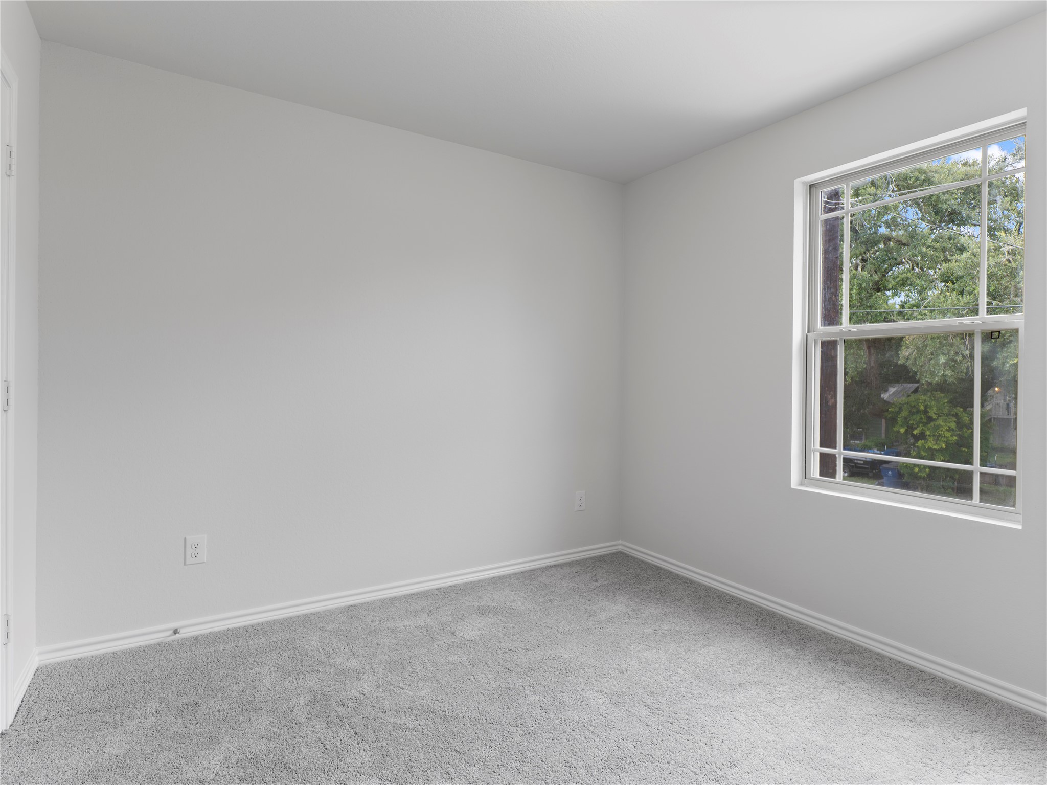 306 North Orange Street Sweeny, TX 77480 - Photo 27 of 30 Cozy upstairs bedroom with soft carpeting and a bright window view.