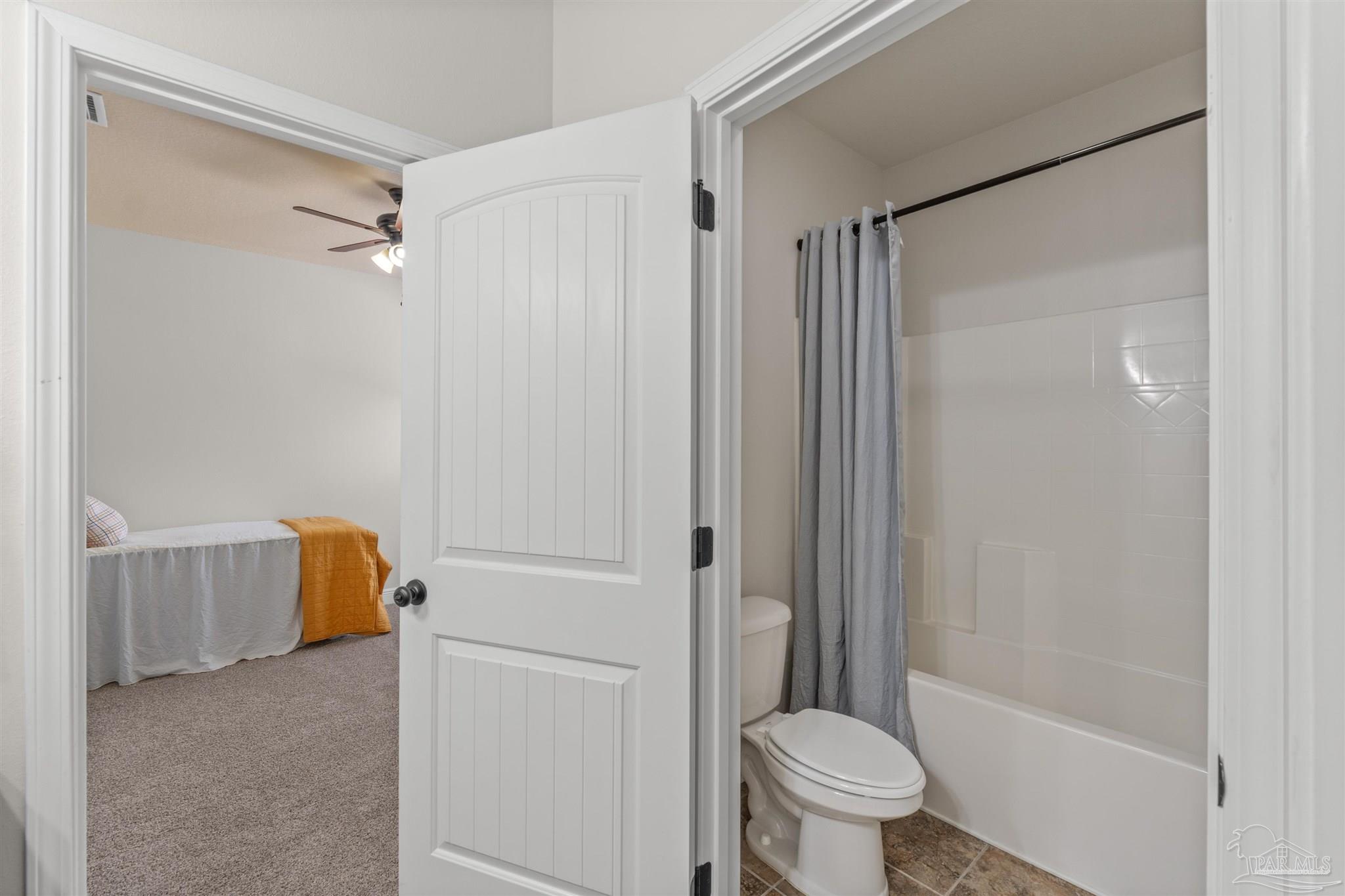 2698 Tulip Hill Road Pace, FL 32571 - Photo 27 of 65 a bathroom with a shower and a toilet