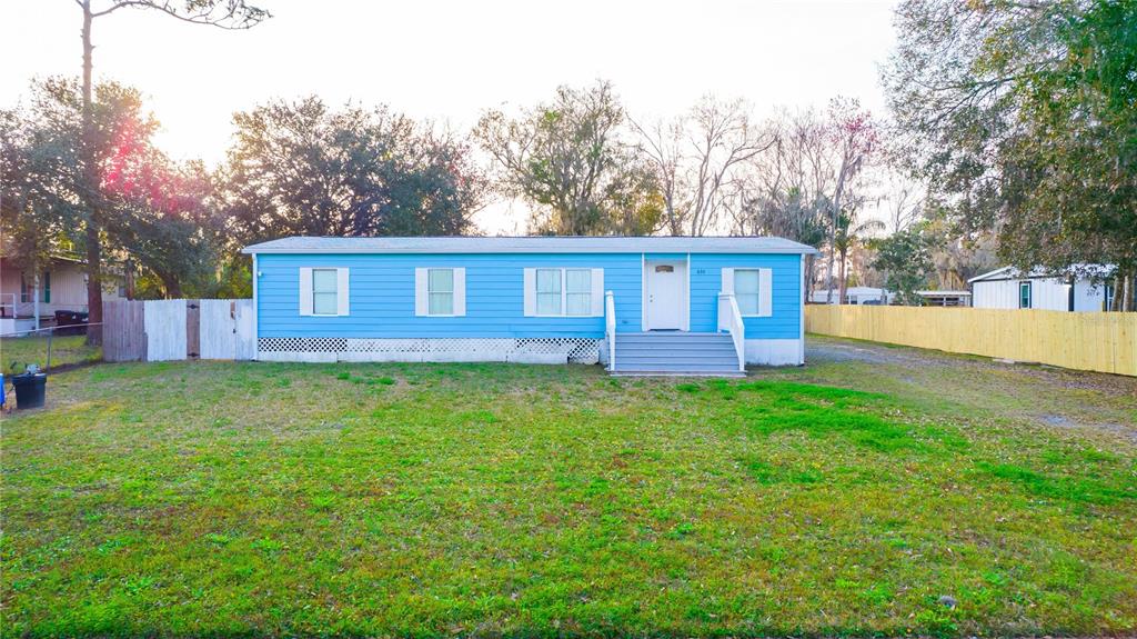 a view of a house with a backyard