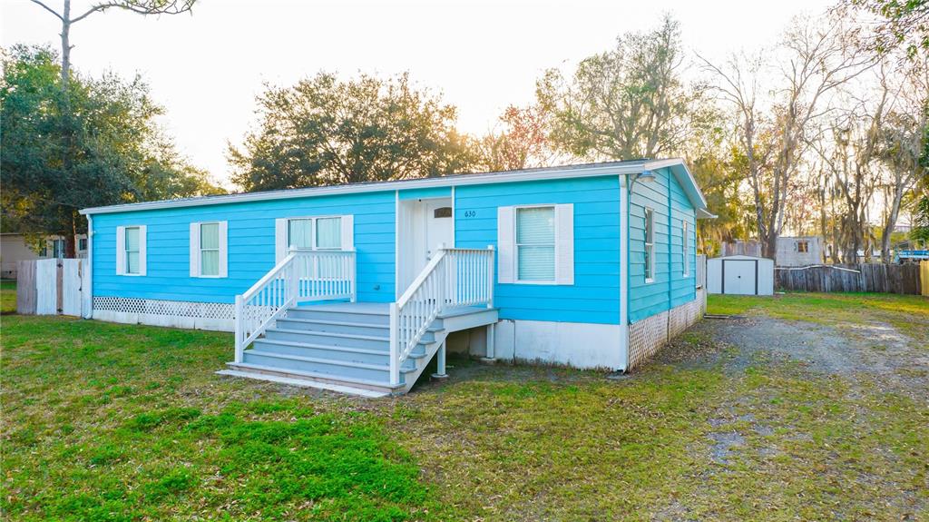 630 Carpenter Road Orlando, FL 32833 - Photo 2 of 23 a view of a house with a yard and wooden fence