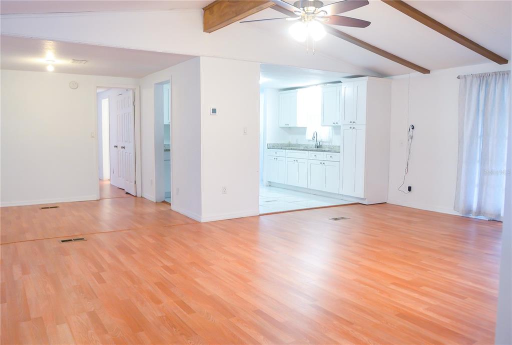 630 Carpenter Road Orlando, FL 32833 - Photo 5 of 23 a view of an empty room with wooden floor and a ceiling fan