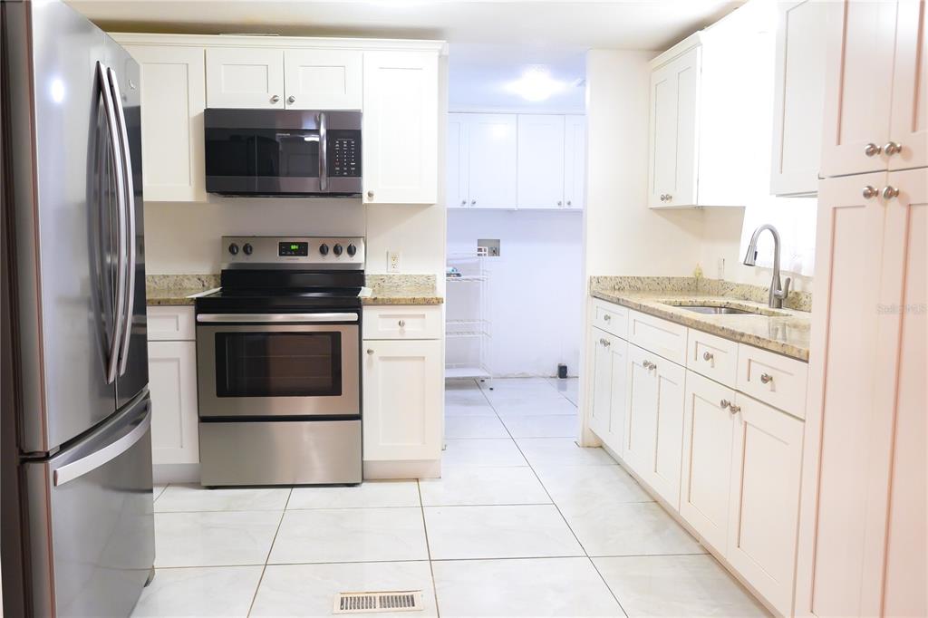 630 Carpenter Road Orlando, FL 32833 - Photo 8 of 23 a kitchen with stainless steel appliances a stove a sink and a refrigerator