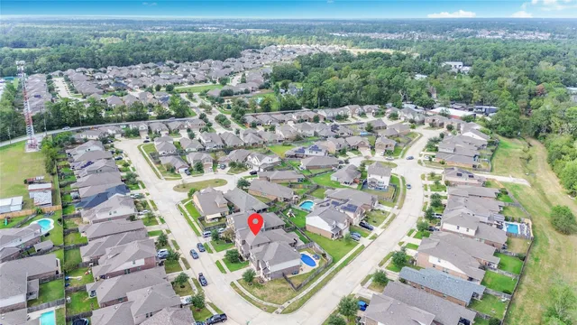 an aerial view of a house with a swimming pool and outdoor seating