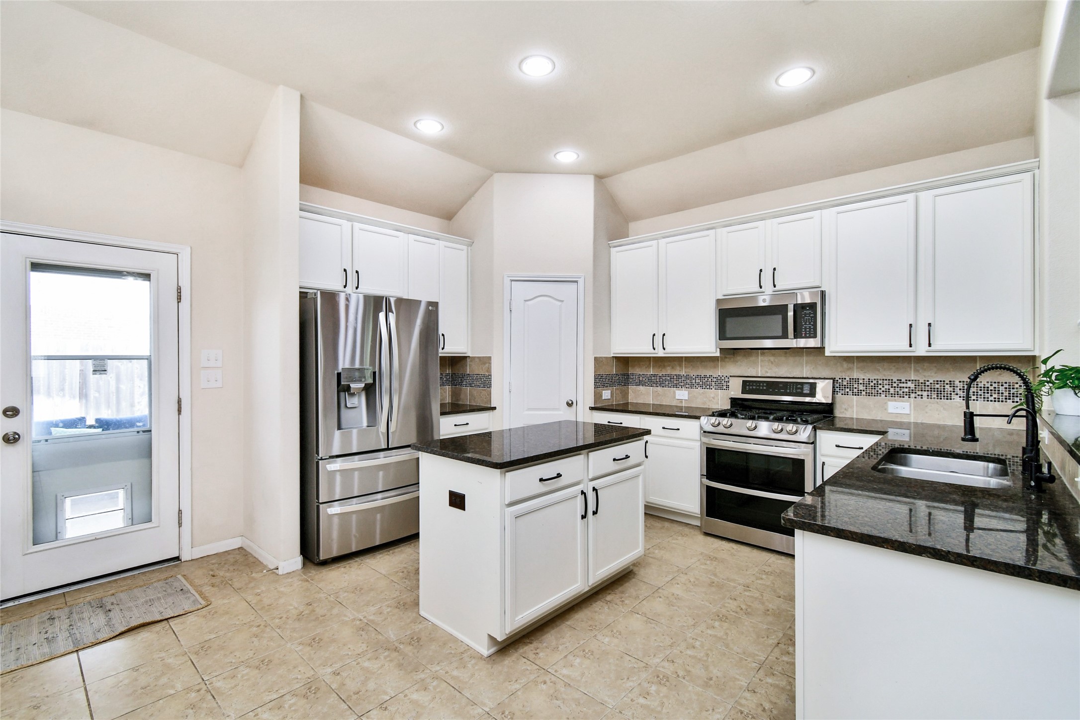 7110 Panther Ridge Drive Spring, TX 77389 - Photo 7 of 25 a kitchen with stainless steel appliances granite countertop a stove top oven a refrigerator a sink and dishwasher