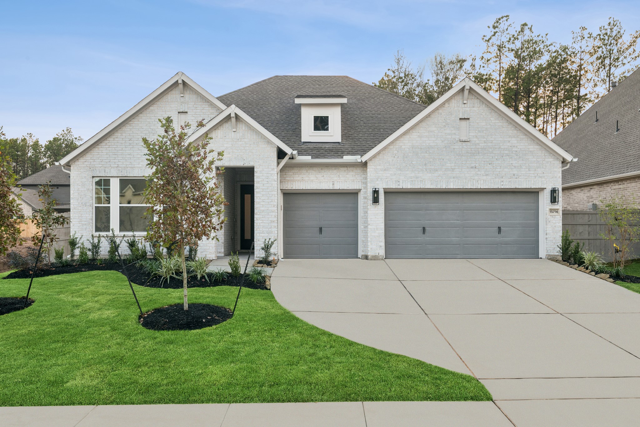 15714 Terracotta Terrace Lane Conroe, TX 77302 - Photo 2 of 47 a front view of a house with a yard and garage