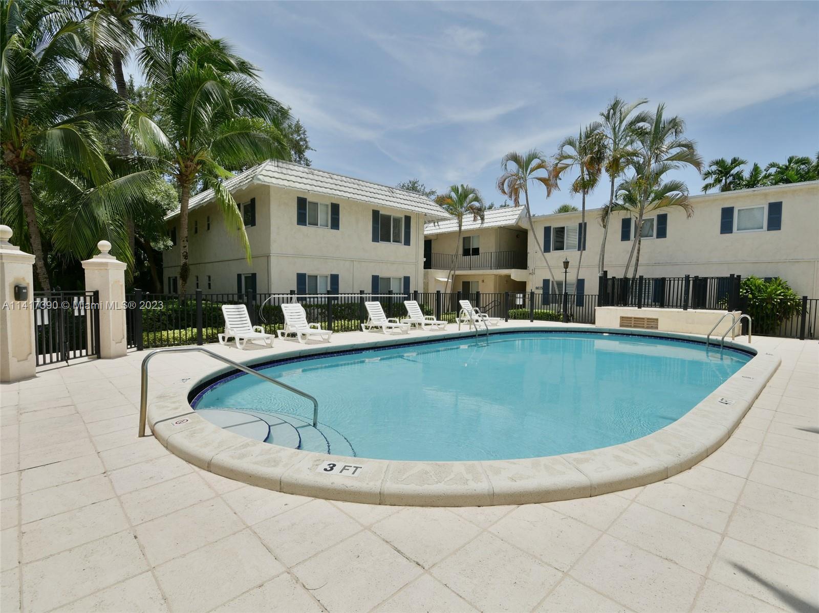 8609 Southwest 68th Court, Unit 5 Pinecrest, FL 33156 - Photo 13 of 27 a view of a house with swimming pool