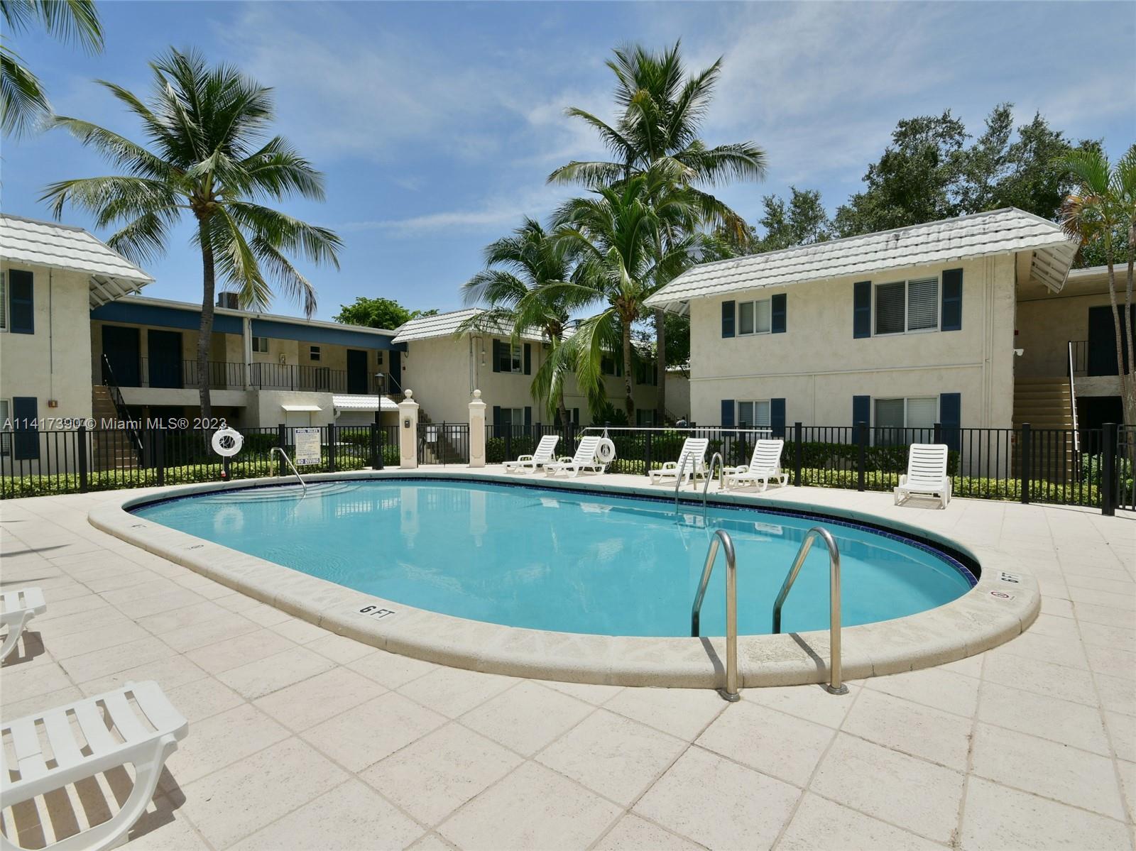 8609 Southwest 68th Court, Unit 5 Pinecrest, FL 33156 - Photo 14 of 27 a view of outdoor space with swimming pool and porch