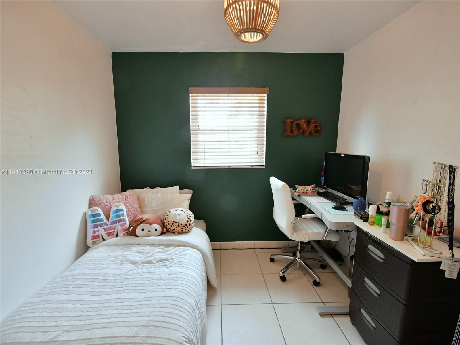 8609 Southwest 68th Court, Unit 5 Pinecrest, FL 33156 - Photo 17 of 27 a bedroom with a workspace
