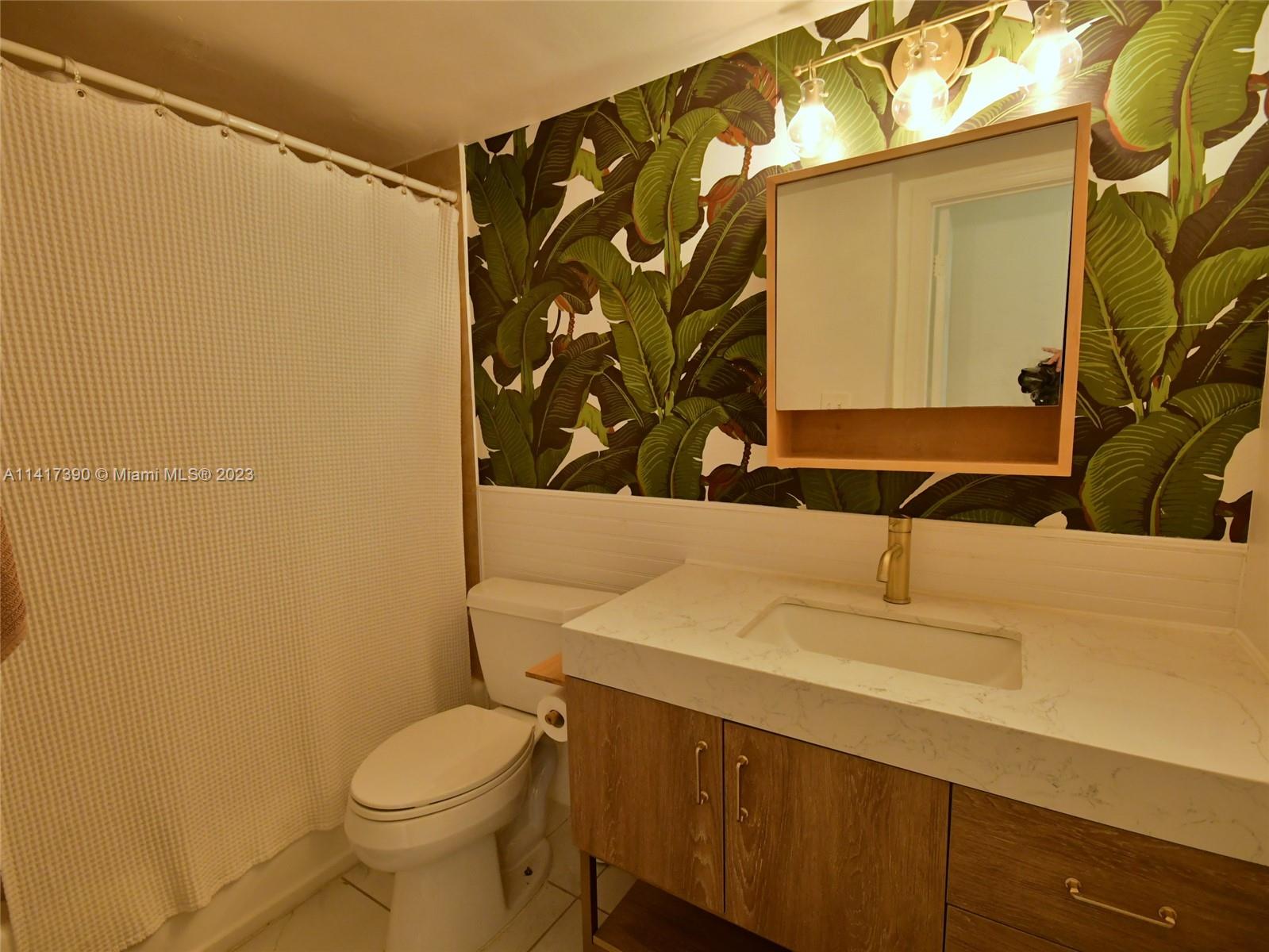 8609 Southwest 68th Court, Unit 5 Pinecrest, FL 33156 - Photo 19 of 27 a bathroom with a sink and a toilet