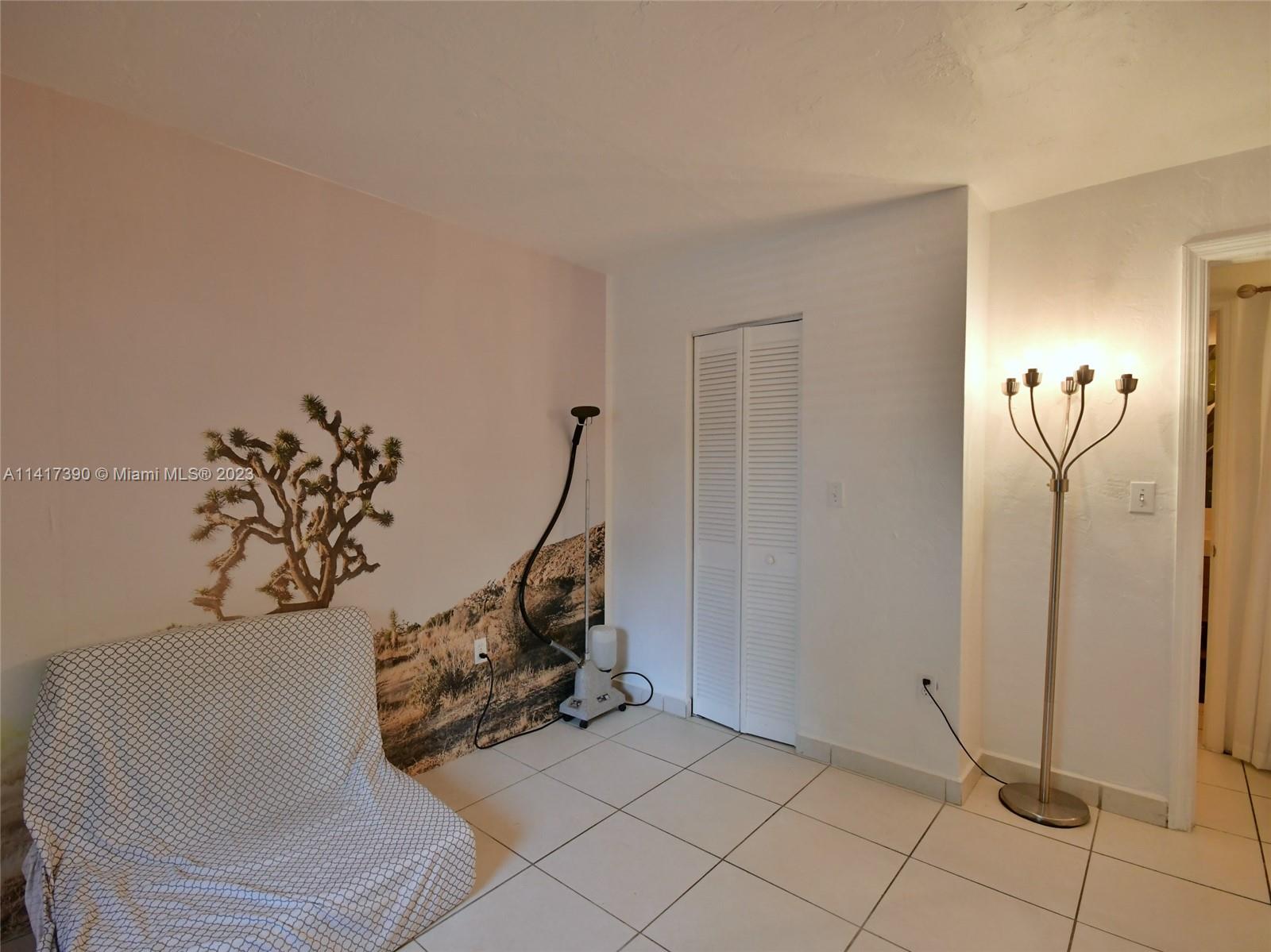 8609 Southwest 68th Court, Unit 5 Pinecrest, FL 33156 - Photo 23 of 27 a view of a room with a table and a chair