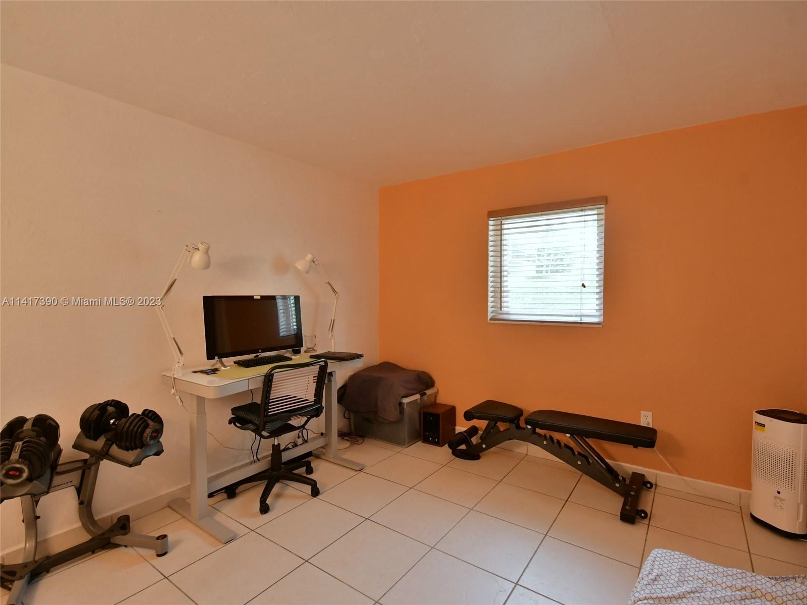 8609 Southwest 68th Court, Unit 5 Pinecrest, FL 33156 - Photo 24 of 27 a view of a workspace with a window