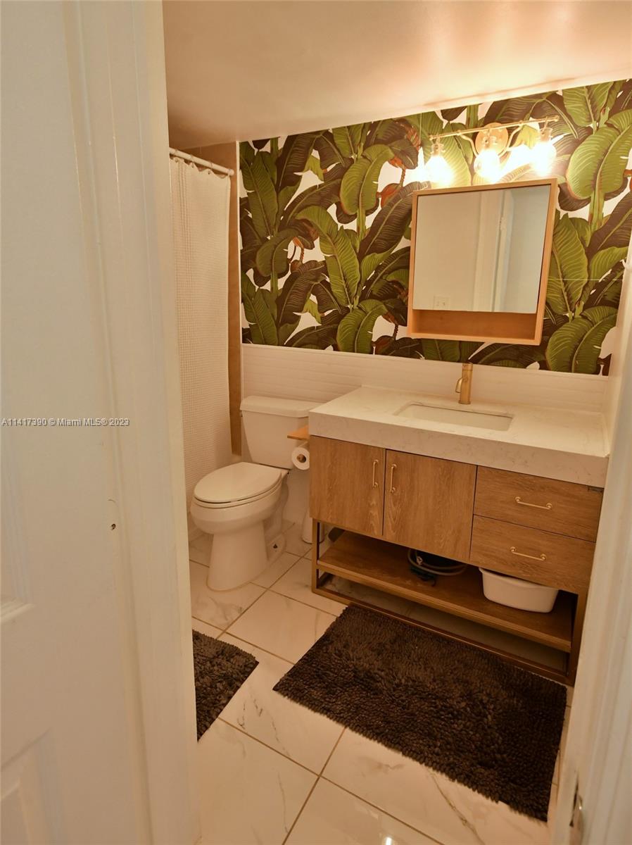 8609 Southwest 68th Court, Unit 5 Pinecrest, FL 33156 - Photo 25 of 27 a bathroom with a toilet and a sink