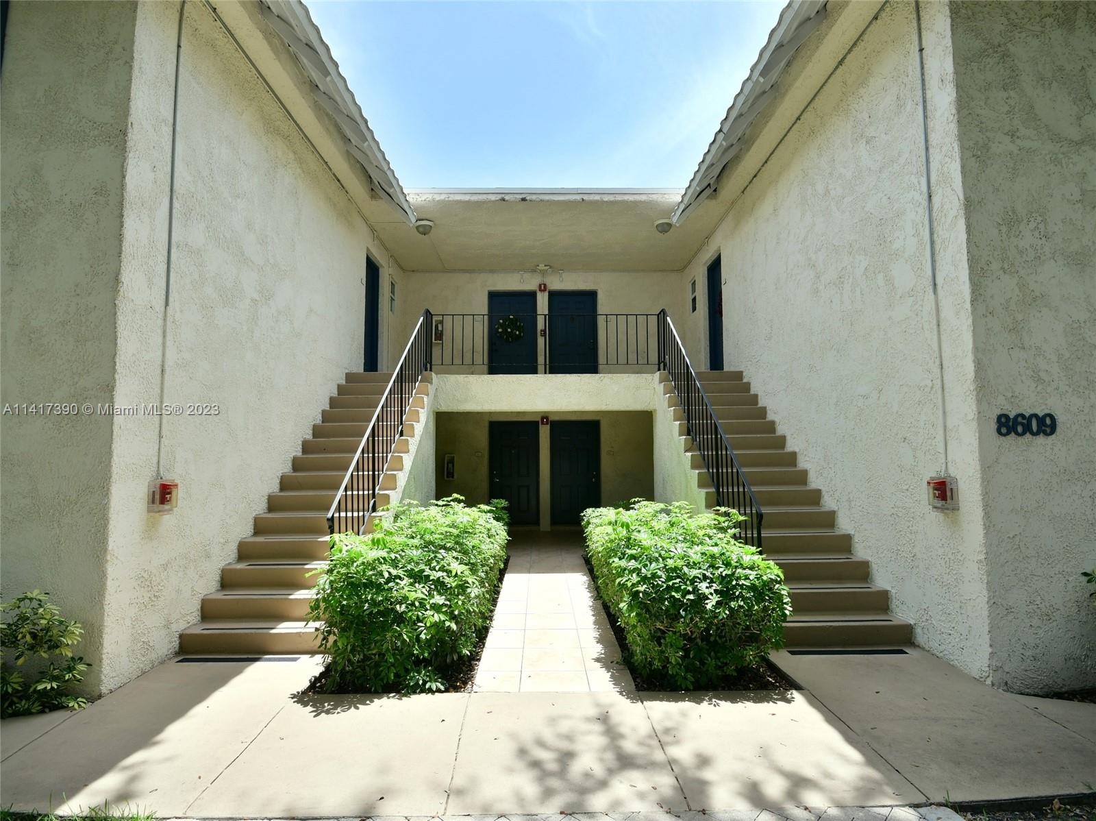 8609 Southwest 68th Court, Unit 5 Pinecrest, FL 33156 - Photo 26 of 27 a view of entryway with flower pots