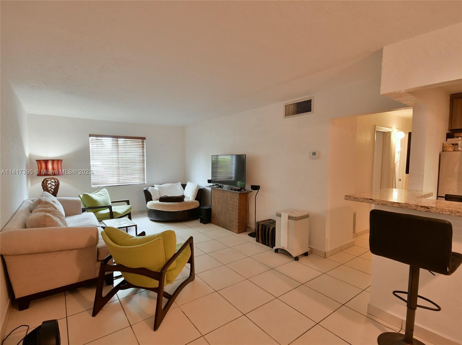 8609 Southwest 68th Court, Unit 5 Pinecrest, FL 33156 - Photo 8 of 27 a living room with furniture and a window