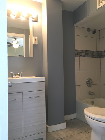 749 Spring Street Aurora, IL 60505 - Photo 17 of 18 a bathroom with a sink a toilet and shower