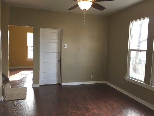 749 Spring Street Aurora, IL 60505 - Photo 4 of 18 a view of an empty room with wooden floor and a window