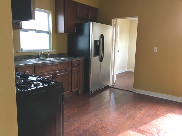 749 Spring Street Aurora, IL 60505 - Photo 6 of 18 a kitchen with granite countertop a refrigerator and a stove