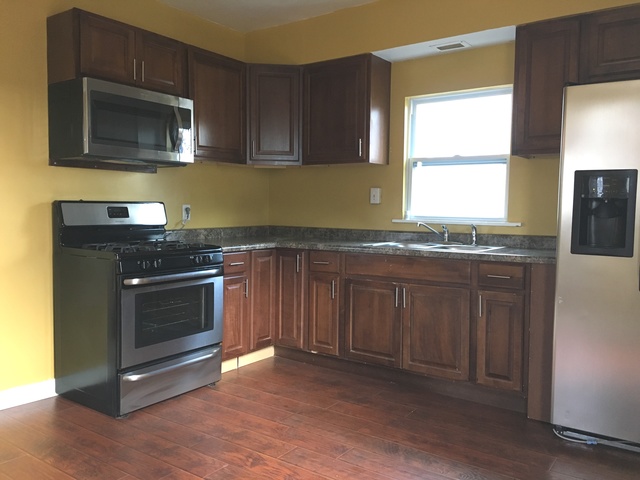 749 Spring Street Aurora, IL 60505 - Photo 8 of 18 a kitchen with granite countertop cabinets stainless steel appliances and a window