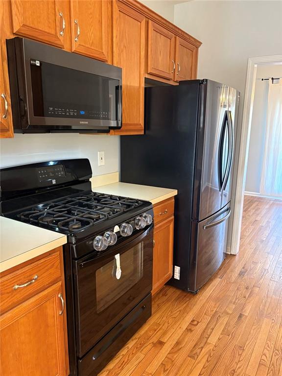 170 Blue Ridge Drive Powder Springs, GA 30127 - Photo 11 of 27 a kitchen with stainless steel appliances and wooden cabinets