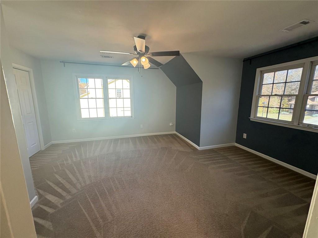 170 Blue Ridge Drive Powder Springs, GA 30127 - Photo 18 of 27 an empty room with windows and fan