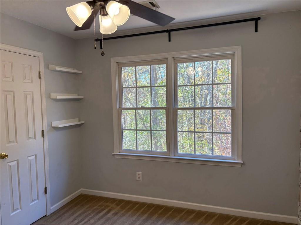 170 Blue Ridge Drive Powder Springs, GA 30127 - Photo 21 of 27 a view of an empty room with a window and wooden floor