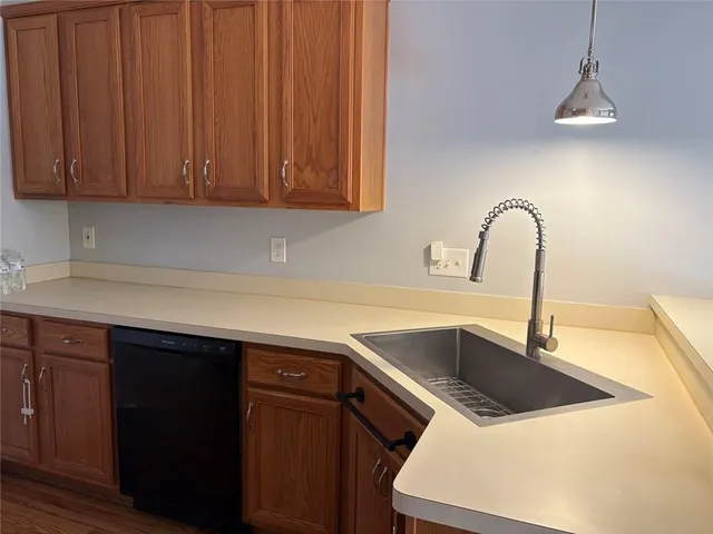 a kitchen with stainless steel appliances and wooden cabinets