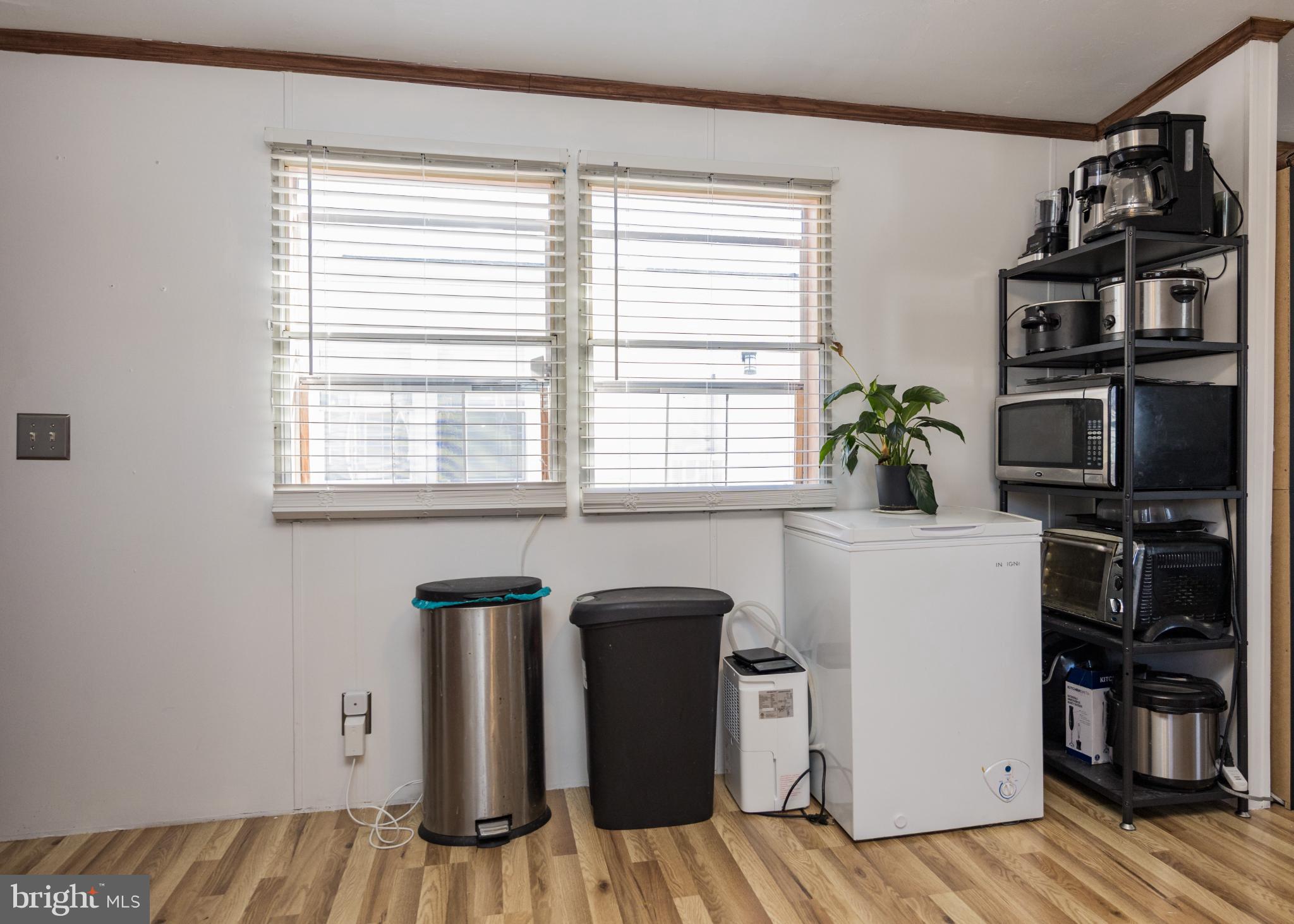 103 Herbert Court Bear, DE 19701 - Photo 11 of 33 a view of a kitchen with fridge and wooden floor