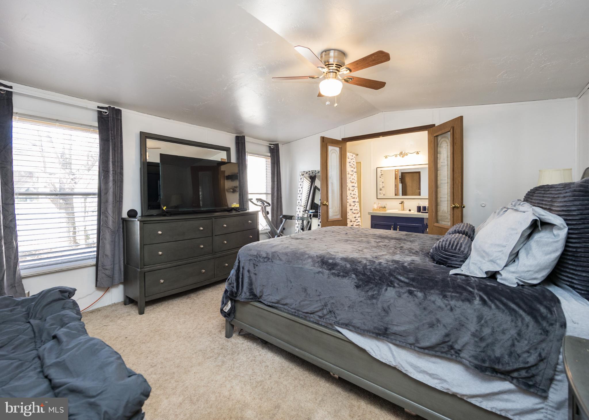 103 Herbert Court Bear, DE 19701 - Photo 20 of 33 a spacious bedroom with a bed and a flat screen tv