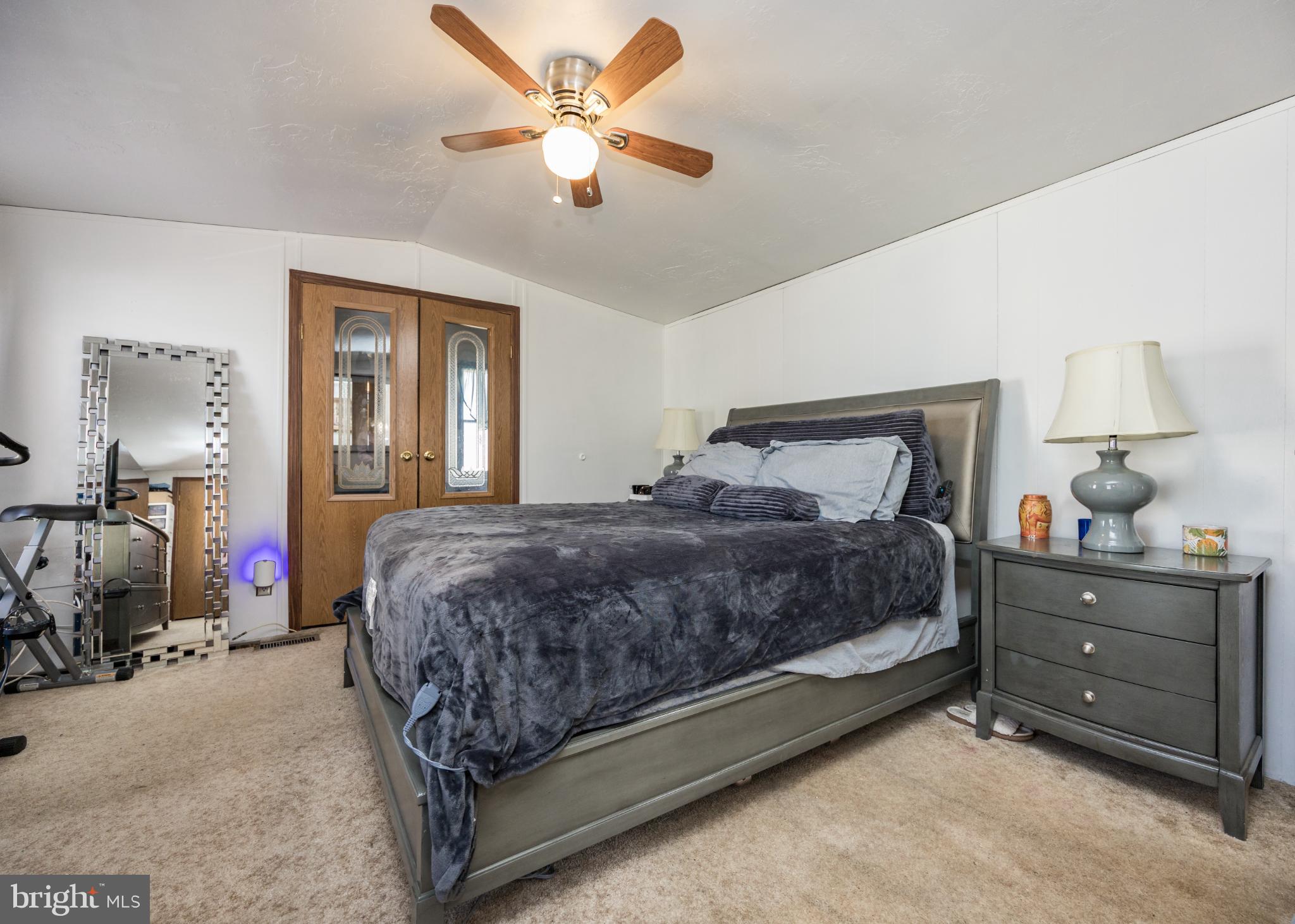 103 Herbert Court Bear, DE 19701 - Photo 28 of 33 a bedroom with a bed and a chandelier