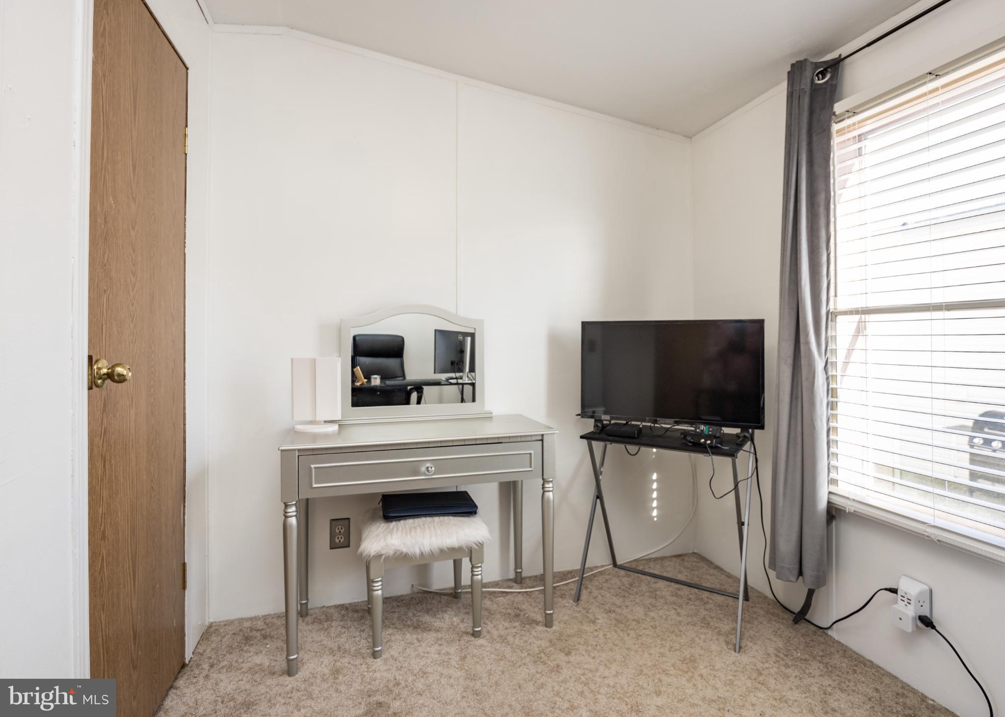 103 Herbert Court Bear, DE 19701 - Photo 32 of 33 a living room with furniture a flat screen tv and a fireplace