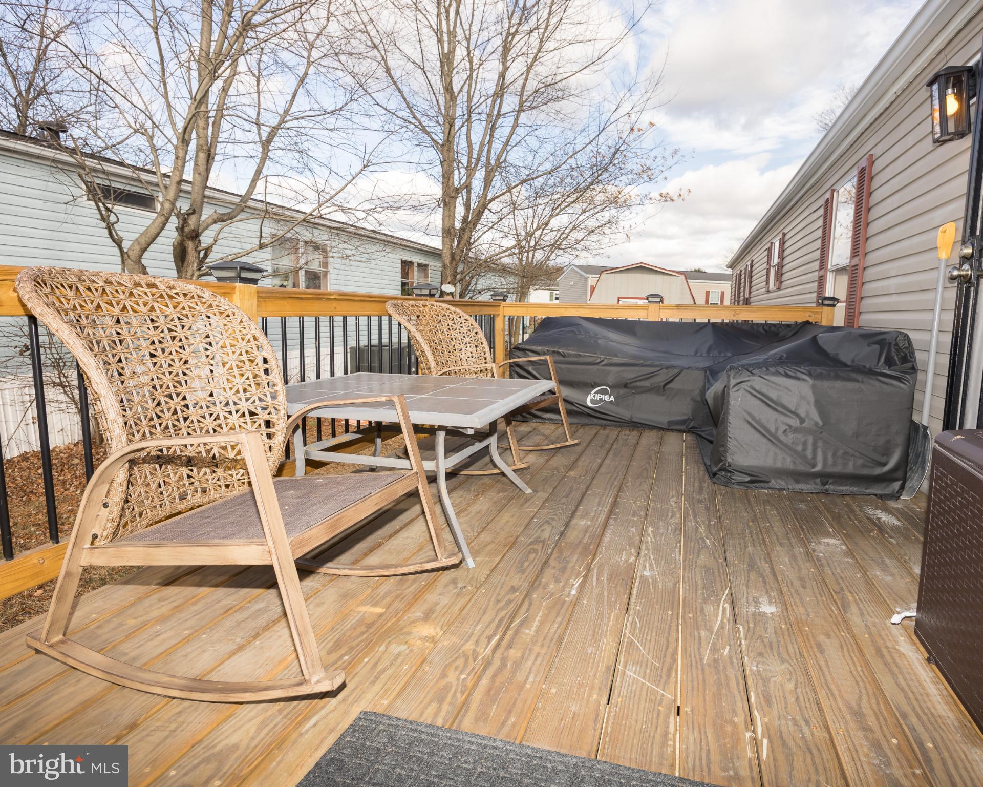 103 Herbert Court Bear, DE 19701 - Photo 4 of 33 a terrace with outdoor seating and wooden floor