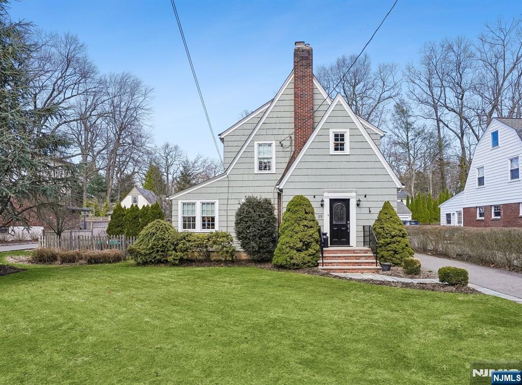a front view of a house with a garden