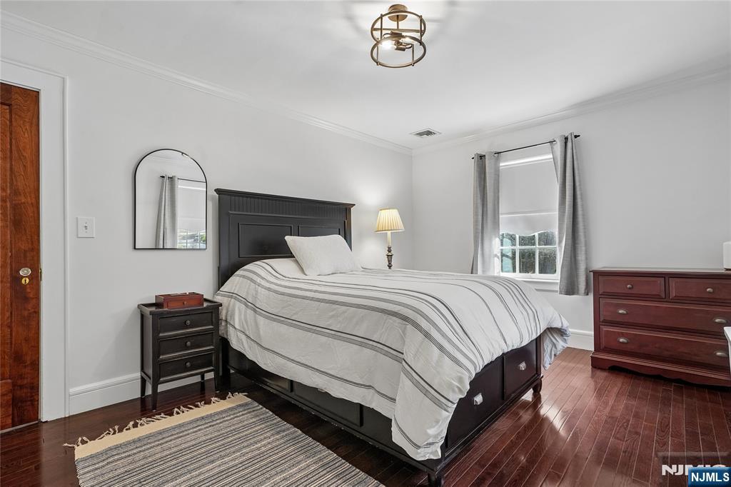 25 Bowers Road Caldwell, NJ 07006 - Photo 18 of 37 a bedroom with a bed and a dresser with wooden floor