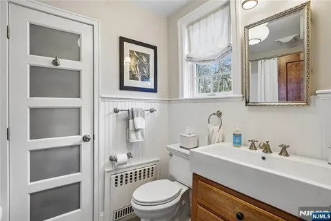 a view of a backyard with potted plants and large tree