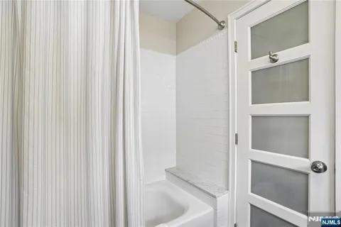 a view of a yard in front of a house with a large tree