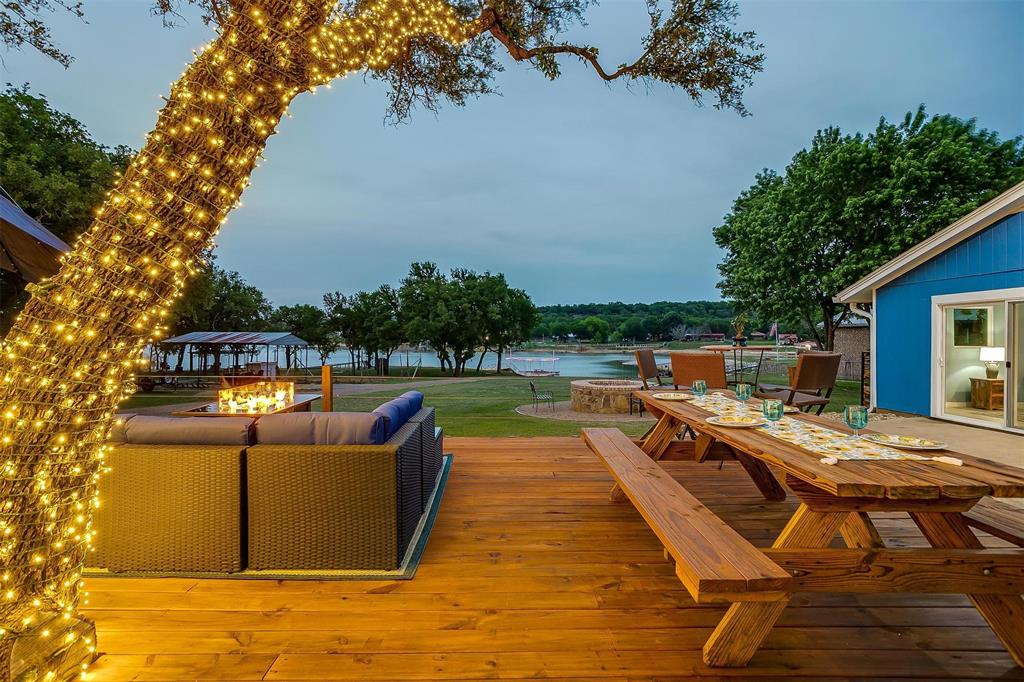 520 Deer Trail Gordon, TX 76453 - Photo 36 of 40 Wooden terrace with an outdoor fire pit, a water view, and outdoor lounge area