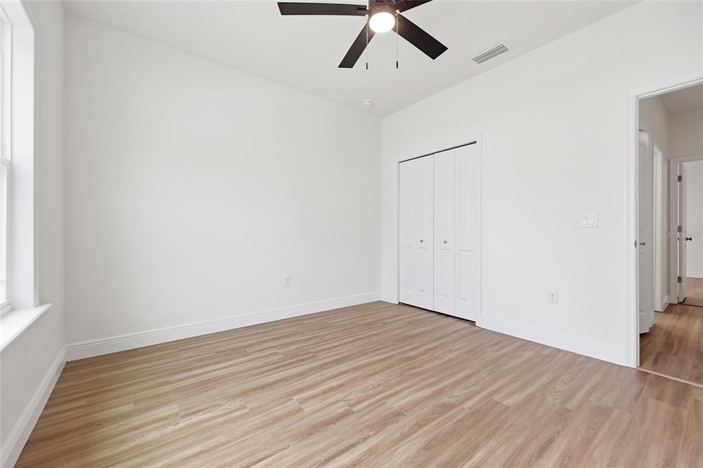 6735 Southwest 10th Lane Gainesville, FL 32607 - Photo 13 of 24 an empty room with wooden floor and windows